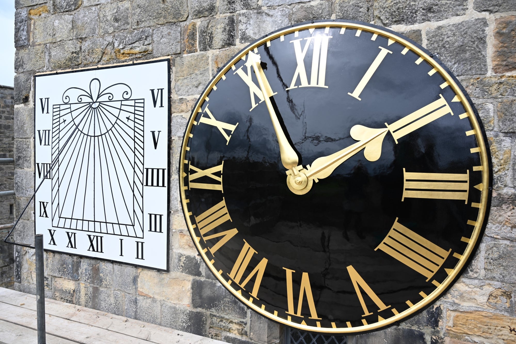 Clock and sundial after Conservation