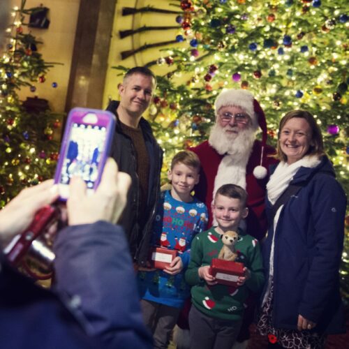 Family taking a photo with santa