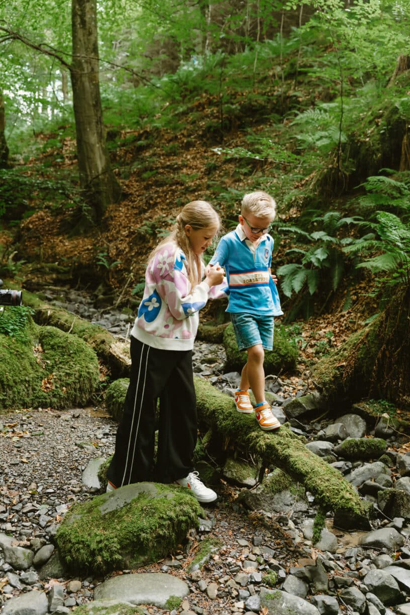Children walking the Little Bumble Bees’ Trail at High Force, looking for bee clues and enjoying nature along a shaded woodland path.
