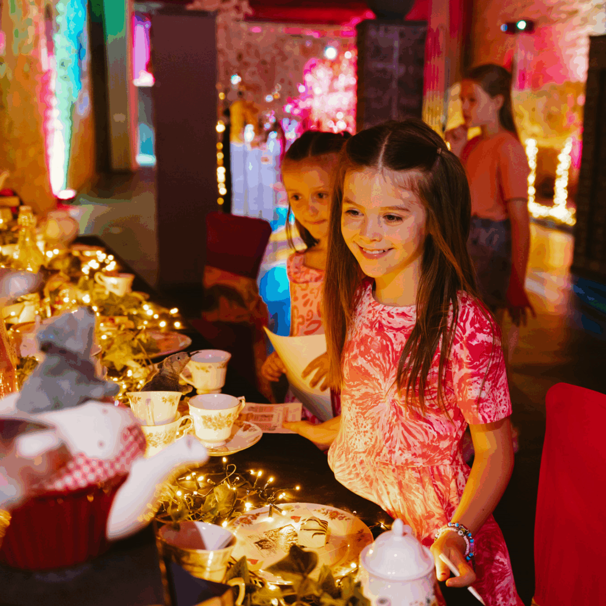 A family enjoying Adventures in Wonderland: An Immersive Experience at Raby Castle – a top children’s activity and summer day out.